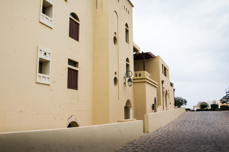 Building on a city street in a summer cloudy dayの写真素材