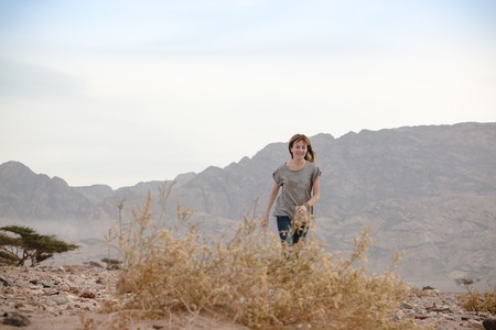 Girl have fun in desert in a summer dayの写真素材
