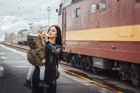 Mother and daughter at the train station in a dayの写真素材