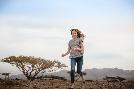 Girl have fun in desert in a summer day