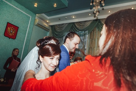 Russia, Kirov - November 24, 2017: Guest or relative congratulates bride and groom in the registry office after wedding registration in Kirov city in 2017のeditorial素材
