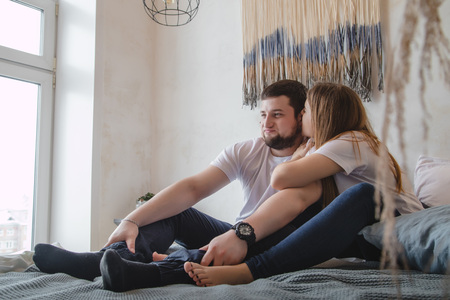 Lovely couple have fun, rest and relax on the bed in the bedroom. Lifestyle conceptの写真素材