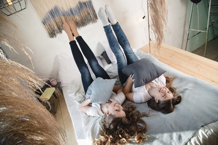 Two beautiful female friends are having fun in the room. Female friendshipの写真素材