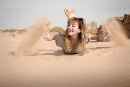 Girl have fun in desert in a summer dayの写真素材