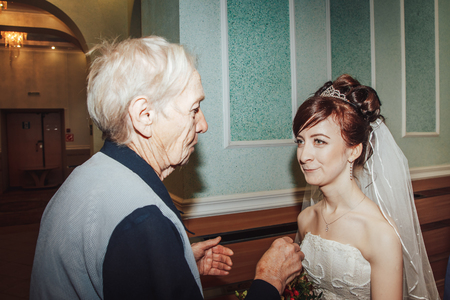 Russia, Kirov - November 24, 2017: Guest or relative congratulates bride and groom in the registry office after wedding registration in Kirov city in 2017のeditorial素材
