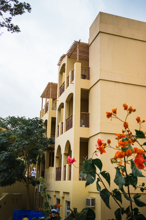 Aqaba, Jordan - December 24, 2017: Building on a city street in a summer cloudy day in Jordanのeditorial素材