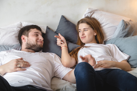 Lovely couple have fun, rest and relax on the bed in the bedroom. Lifestyle conceptの写真素材