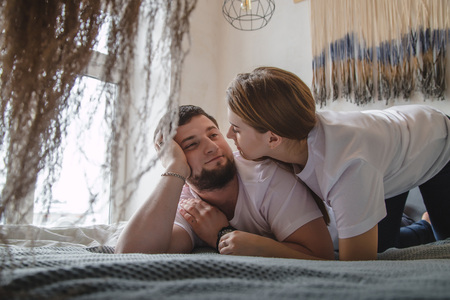 Lovely couple have fun, rest and relax on the bed in the bedroom. Lifestyle conceptの写真素材