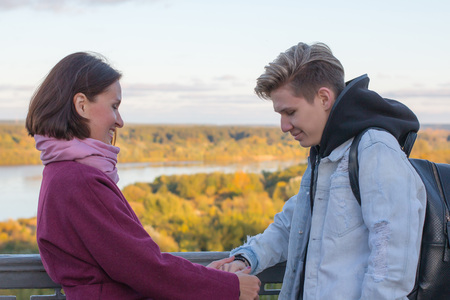 Young mother and adult son outdoor in a autumn dayの写真素材