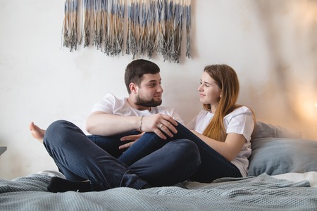 Lovely couple have fun, rest and relax on the bed in the bedroom. Lifestyle conceptの写真素材