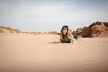 Girl have fun in desert in a summer dayの写真素材