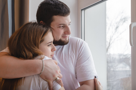 Lovely couple have fun and relax at home near window. Lifestyle conceptの写真素材