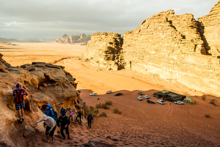 Wadi Rum, Jordan - December, 25, 2017: Tourists in the dunes in Wadi Rum desert in Jordanのeditorial素材