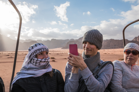 Wadi Rum, Jordan - December, 25, 2017: Tourists in bedouin's car jeeps in Wadi Rum desert in Jordanのeditorial素材