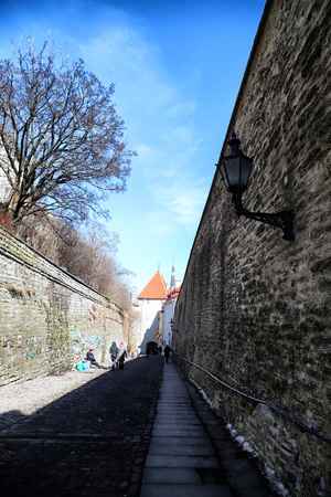 Tallin, Estonia - March 31, 2018: Wall of fortress with towers in the Old town in Tallinn, Estonia. The towers have a red tiled roofのeditorial素材