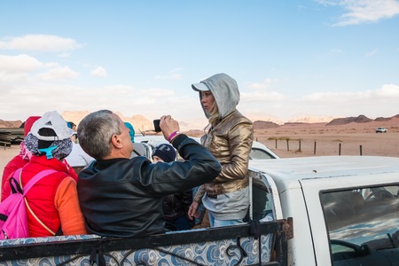 Wadi Rum, Jordan - December, 25, 2017: Tourists in bedouin's car jeeps in Wadi Rum desert in Jordanのeditorial素材