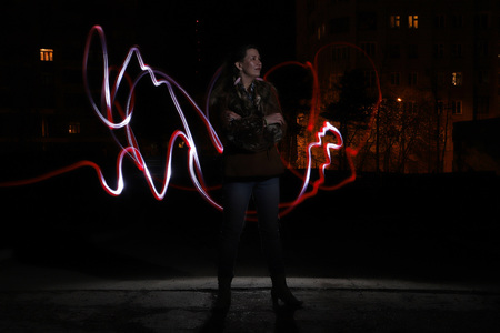 Ugly woman on night street and light line near her. Freezelightの写真素材