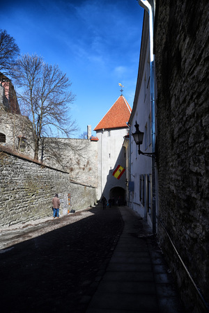 Tallin, Estonia - March 31, 2018: Wall of fortress with towers in the Old town in Tallinn, Estonia. The towers have a red tiled roofのeditorial素材