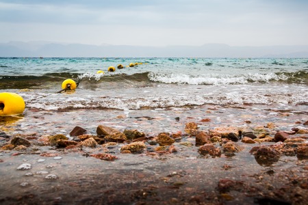 Panoramic view of sea and waves in cloudy dayの写真素材