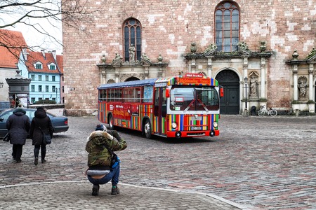 Riga, Latvia - April 01, 2018: Touristic red double-decker hop-on hop-off City Sightseeing tour bus on the street of Riga cityのeditorial素材