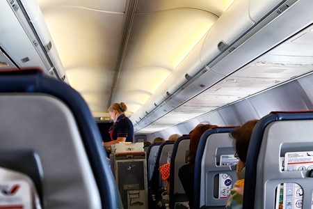 Kazan, Russia - May 19, 2018: Interior of airplane with passengers on seats and stewardess walking the aisle during her workのeditorial素材
