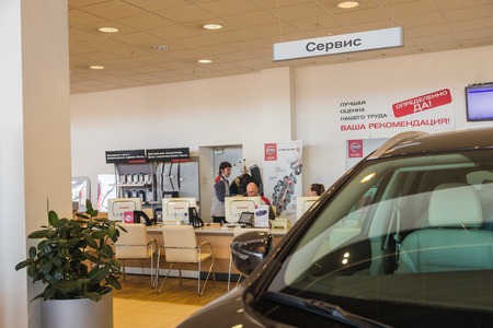 Kirov, Russia - March 14, 2018: Car and manager in showroom of dealership Nissan in Nizhny...