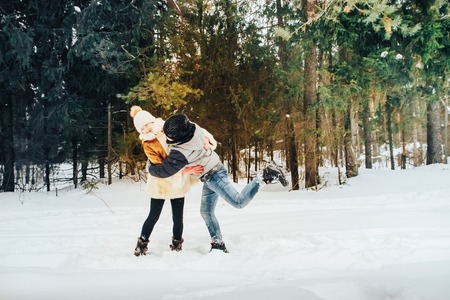 Children have fun in pein forest full of white snow in a winter dayの写真素材