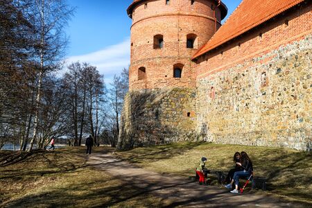 Trakai, Lithuania - April 04, 2018: Island castle in Trakai and tourist near it. One of the most popular touristic destinations in Lithuania in early springのeditorial素材