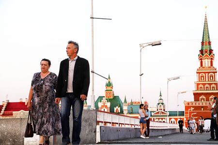 Yoshkar-Ola city, Republic of Mari El, Russia - August 30, 2018: View of the Blagoveshchenskaya Spasskaya Tower and people walking on the square of Yoshkar-Ola city in Russiaのeditorial素材