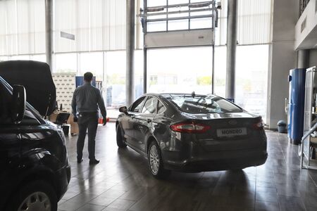 Kazan, Russia - May 27, 2018: Manager and car in showroom of dealership Ford in Kazan in 2018