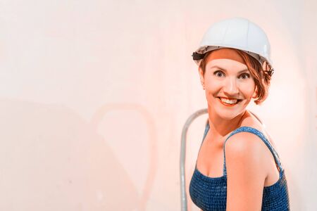 Sexy cute girl who is builder, painter, worker being in a renovated roomのeditorial素材