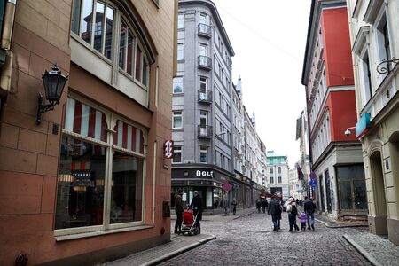 RIGA , LATVIA - April 01, 2018: Street and houses on it in old part of Riga city in cloudy spring...