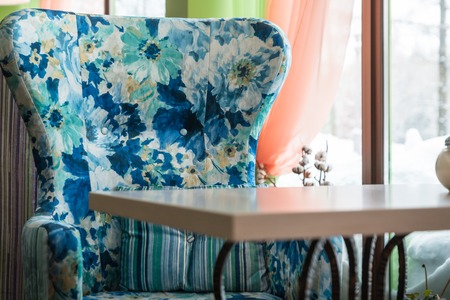 Nice colored armchair at the table in a bright roomの写真素材
