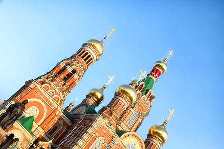The roof of the church with white turrets and domes with crosses is located on the background of a blue sky in a nice day. Oblique compositionの写真素材