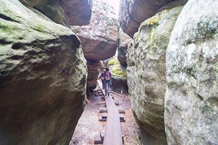Kudowa Zdroj, Poland - September 15, 2018: Sandstone Errant Rocks labyrinth in the Table Mountain in National Park in Poland and tourist in it in a summer dayのeditorial素材