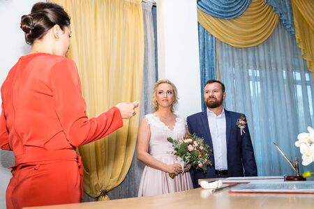 Kirov, Russia - October 12, 2018: Bride and groom signing marriage wedding certificate at registryのeditorial素材