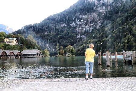 Germany, Koenigssee - September 16, 2018: Beautiful lake and pier with tourist in Koenigssee in Germany in summer dayのeditorial素材