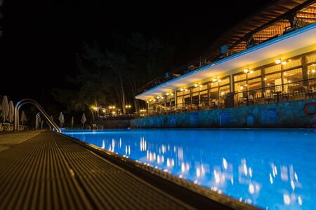 Marmaris, Turkey - May 23, 2018: Swimming pool and sunbed in hotel at night. Blue water with backlightのeditorial素材