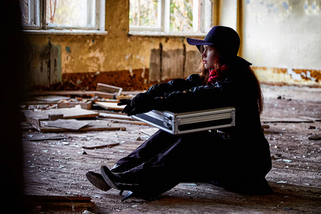 Girl in a black cloak and hat with a diplomat in a ruined room. A spy in a secret meeting. Unusual...