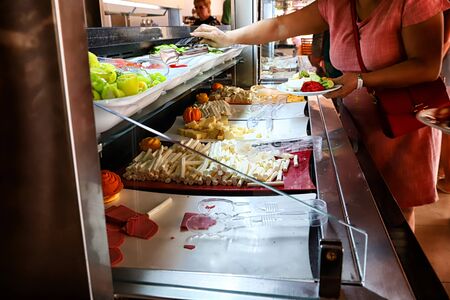 Turkey, Alanya - May 20. 2018: Food on the shelves in the self-service buffet with all inclusive and people near it in the hotel in Turkeyのeditorial素材