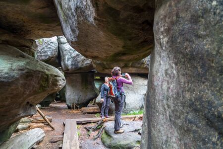 Kudowa Zdroj, Poland - September 15, 2018: Sandstone Errant Rocks labyrinth in the Table Mountain in National Park in Poland and tourist there in a summer dayのeditorial素材