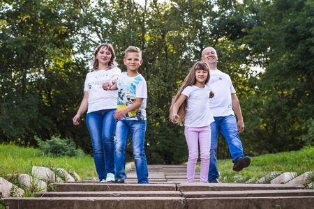 Kirov, Russia - August 21, 2018: Happy family in the Park. Mom, dad, son and daughter during a walk in the summer dayのeditorial素材