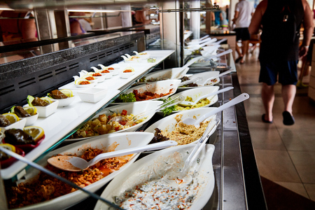 Food on the shelves in the self-service buffet with all inclusive in the hotel in Turkeyの写真素材