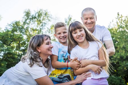 Kirov, Russia - August 21, 2018: Happy family in the Park. Mom, dad, son and daughter during a walk...