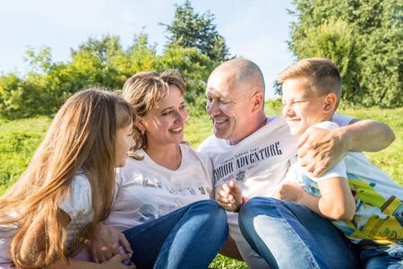 Kirov, Russia - August 21, 2018: Happy family in the Park. Mom, dad, son and daughter during a walk in the summer dayのeditorial素材