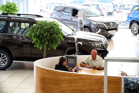 Kazan, Russia - August 31, 2018: Manager and buyer in car showroom of dealership Toyota in Kazan cityのeditorial素材