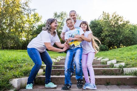 Kirov, Russia - August 21, 2018: Happy family in the Park. Mom, dad, son and daughter during a walk...
