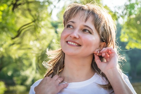 Ordinary girl with plump cheeks in the Park in a Sunny summer day