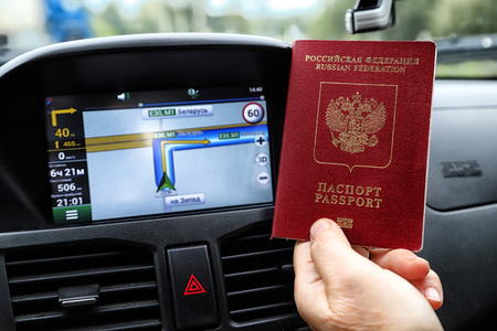 Russian passports and car Navigator in the background. Concept of travel abroad by car for Russian citizensの写真素材
