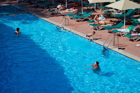 Marmaris, Turkey - May 23, 2018: Swimming pool in hotel and people are enjoying sunny weather on sunbed near it. Top viewのeditorial素材